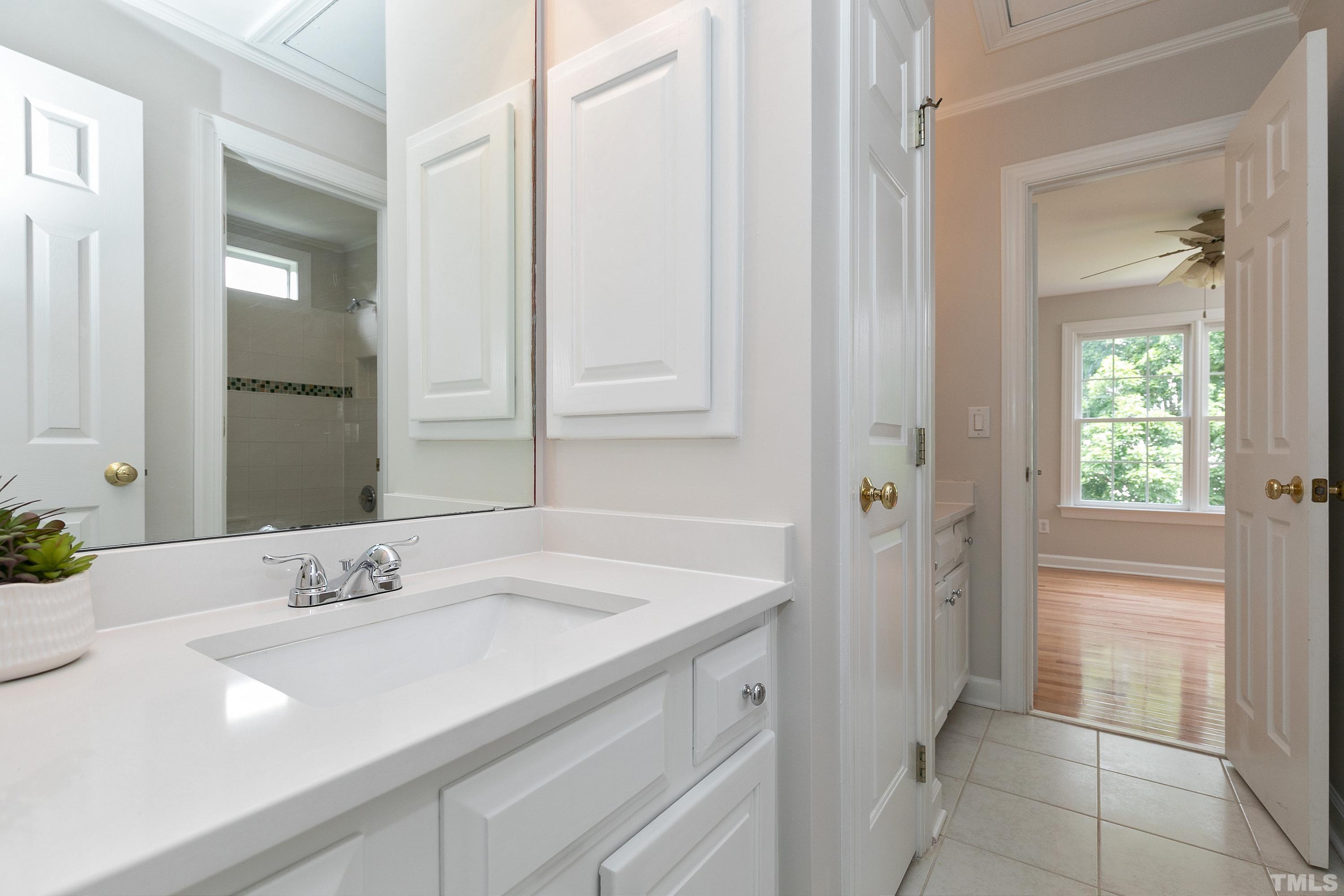 Jack & Jill Bath connects to 2 bedrooms with separate vanities and a separate shower room. Vanity with new QUARTZ top.