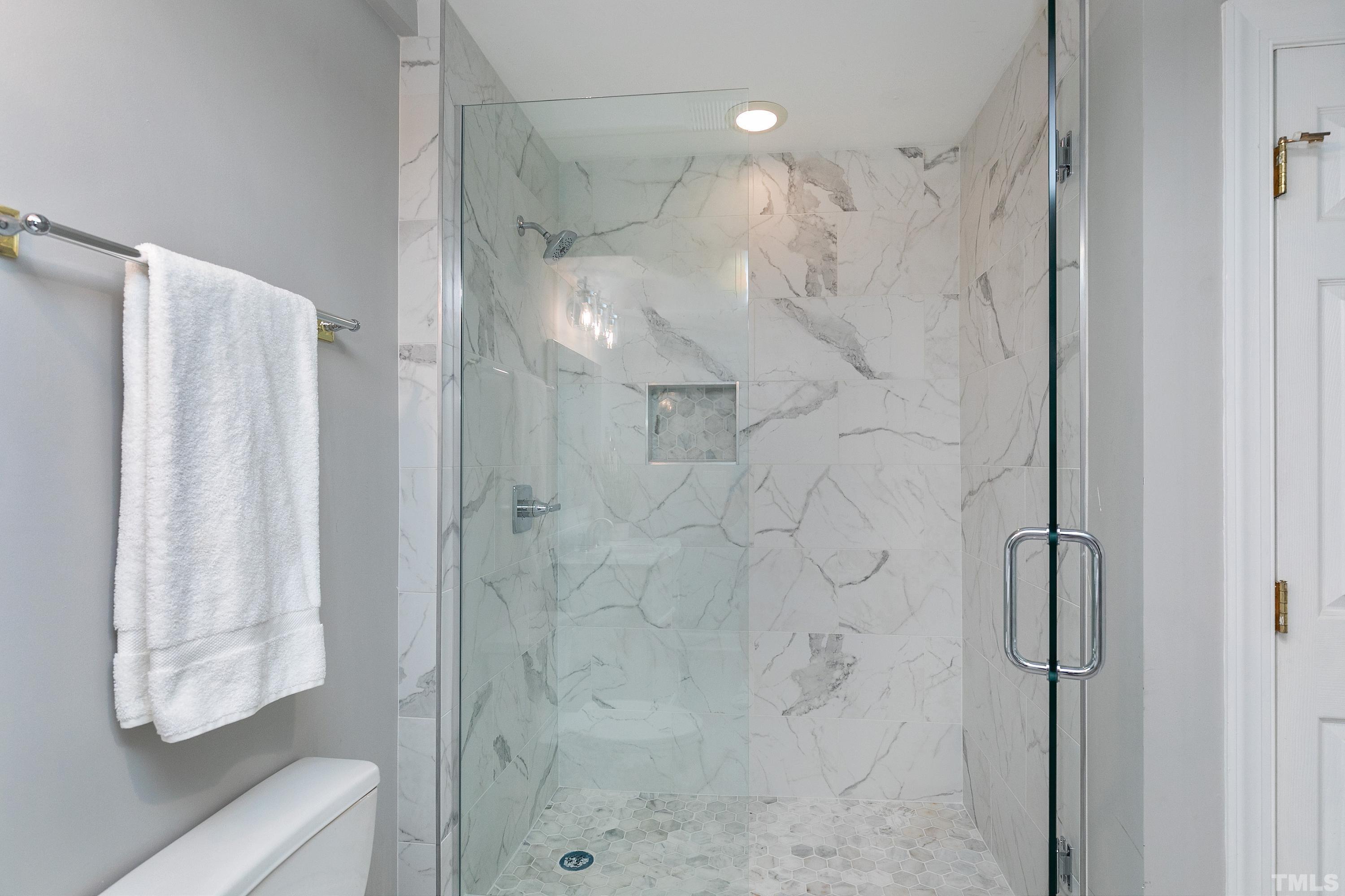NEWLY RENOVATED FULL BATH with tiled walk in shower, new vanity & luxury vinyl plank floor.