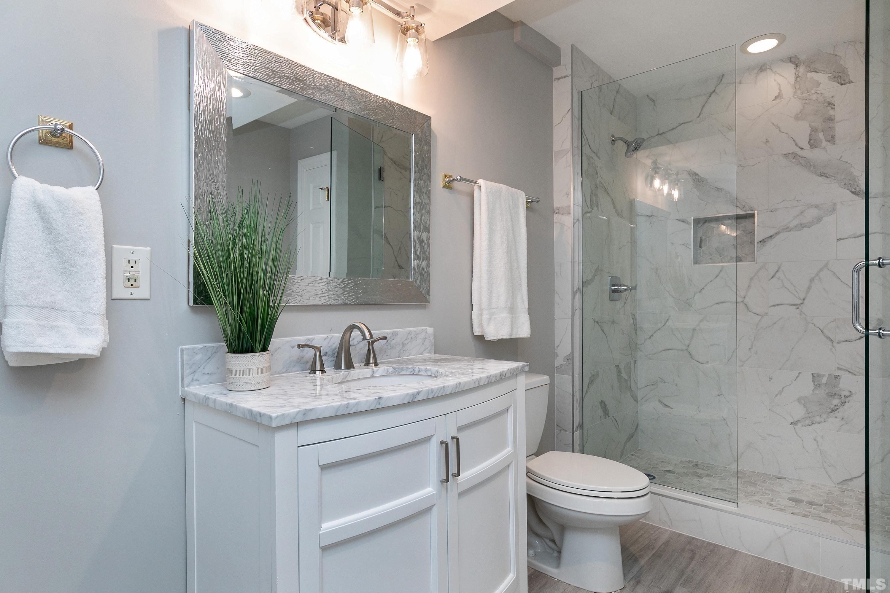NEWLY RENOVATED FULL BATH with tiled walk in shower, new vanity & luxury vinyl plank floor.