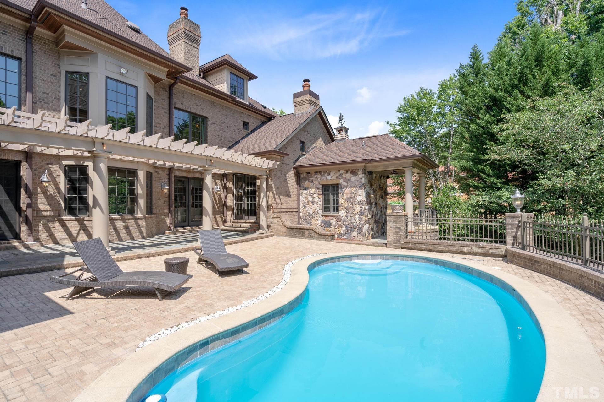 Plenty of sunning space on the bricked pool deck for your many summer pool parties & cookouts are easy with a gas line for the grill. Pool is heated & has lights. Notice the beautiful pergola that adorns the back patio and the fountain on the wall!