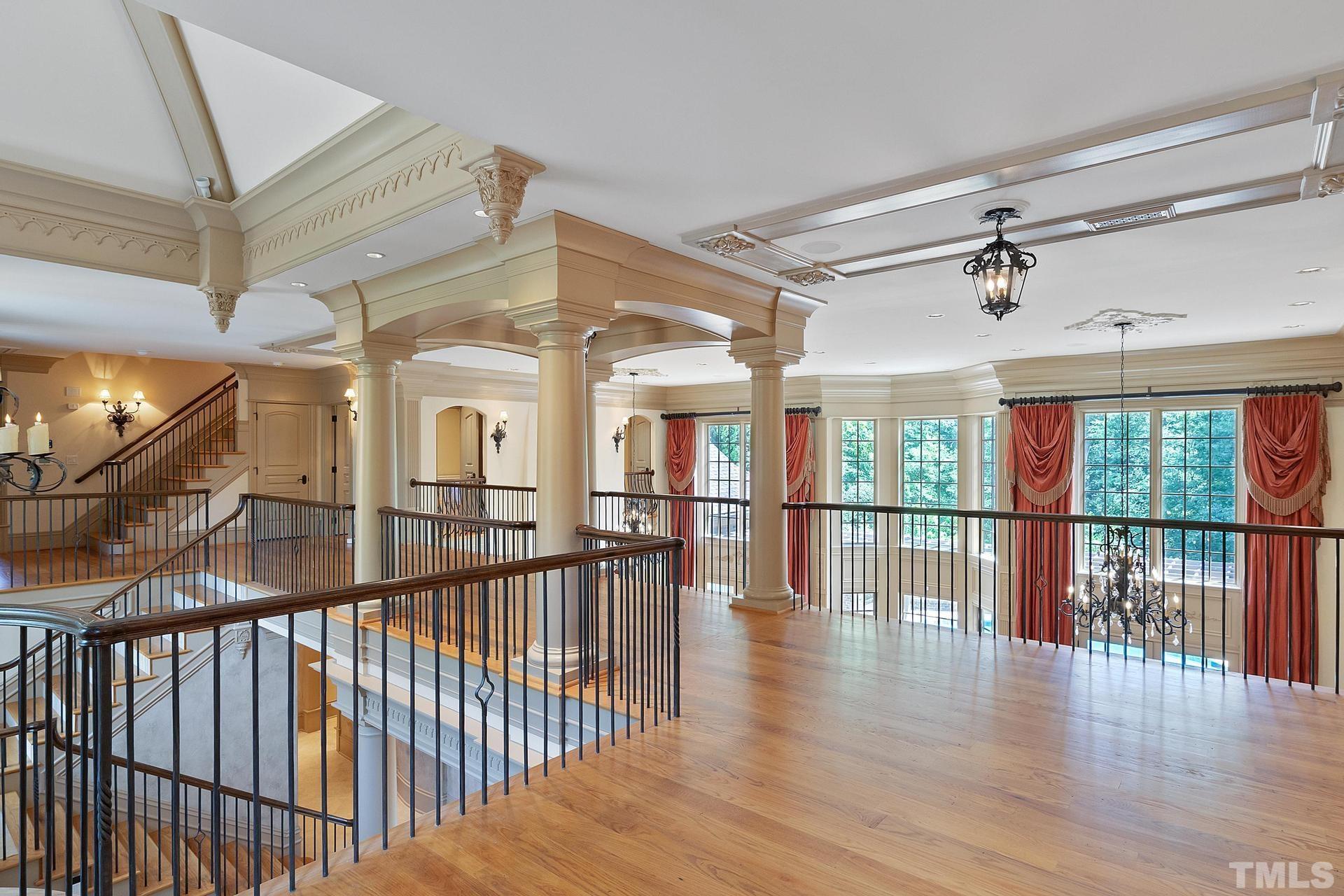 Gorgeous floors, moldings, trim and lighting extend into the upper hallways.