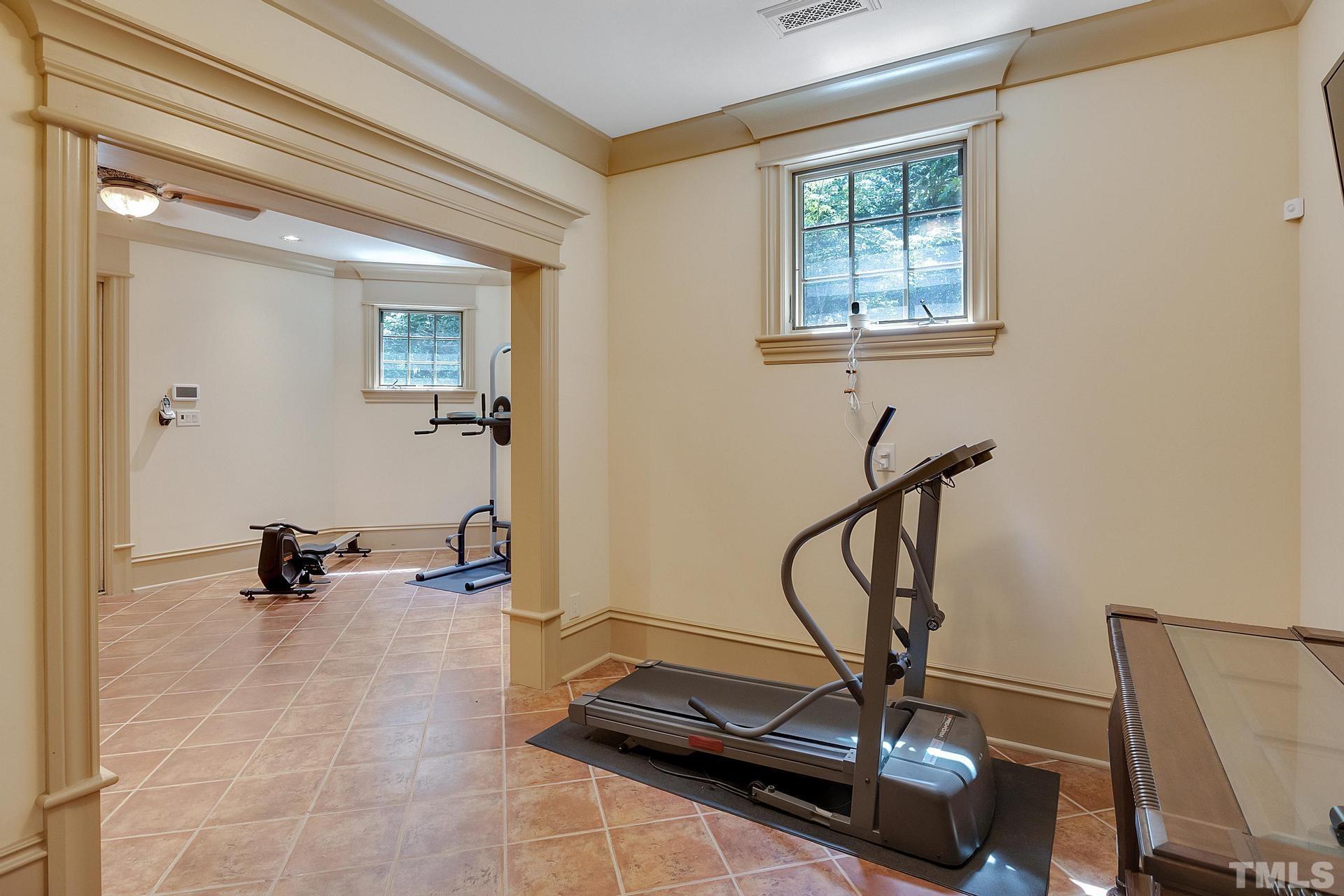 The basement fitness room has its own covered patio leading to he backyard.