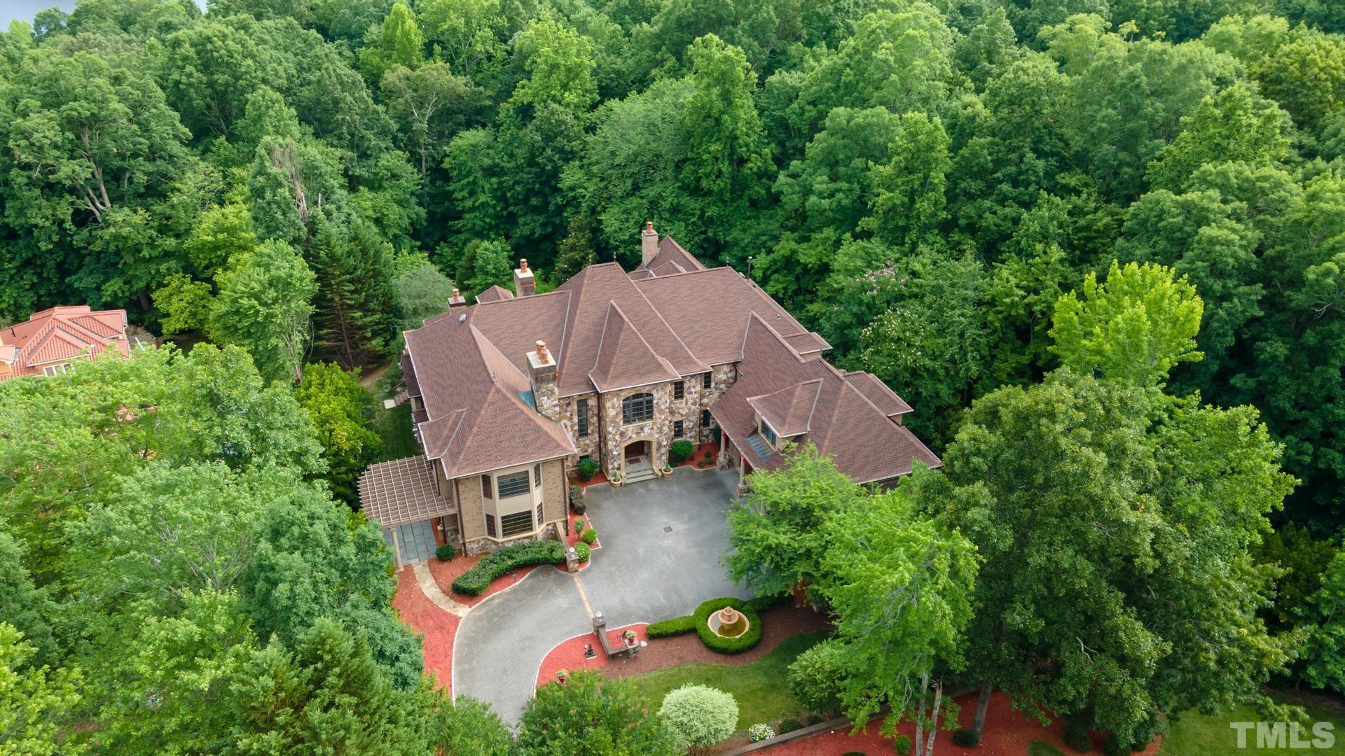 Aerial View of the back of the home shows privacy all around the home. Power outage? No problem, notice the generator!