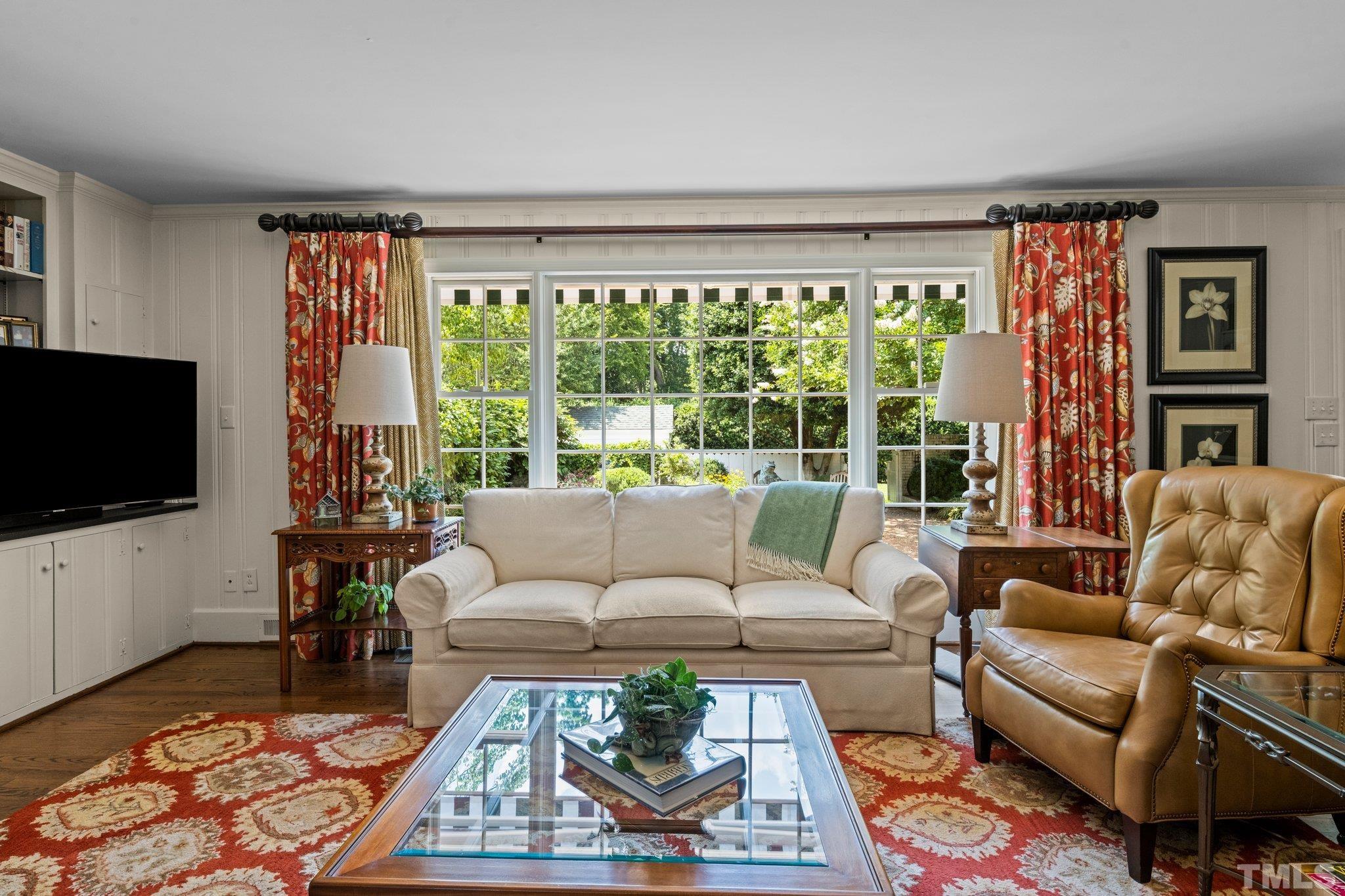 Large window allows natural light inside and views of the gorgeous garden/patio area.