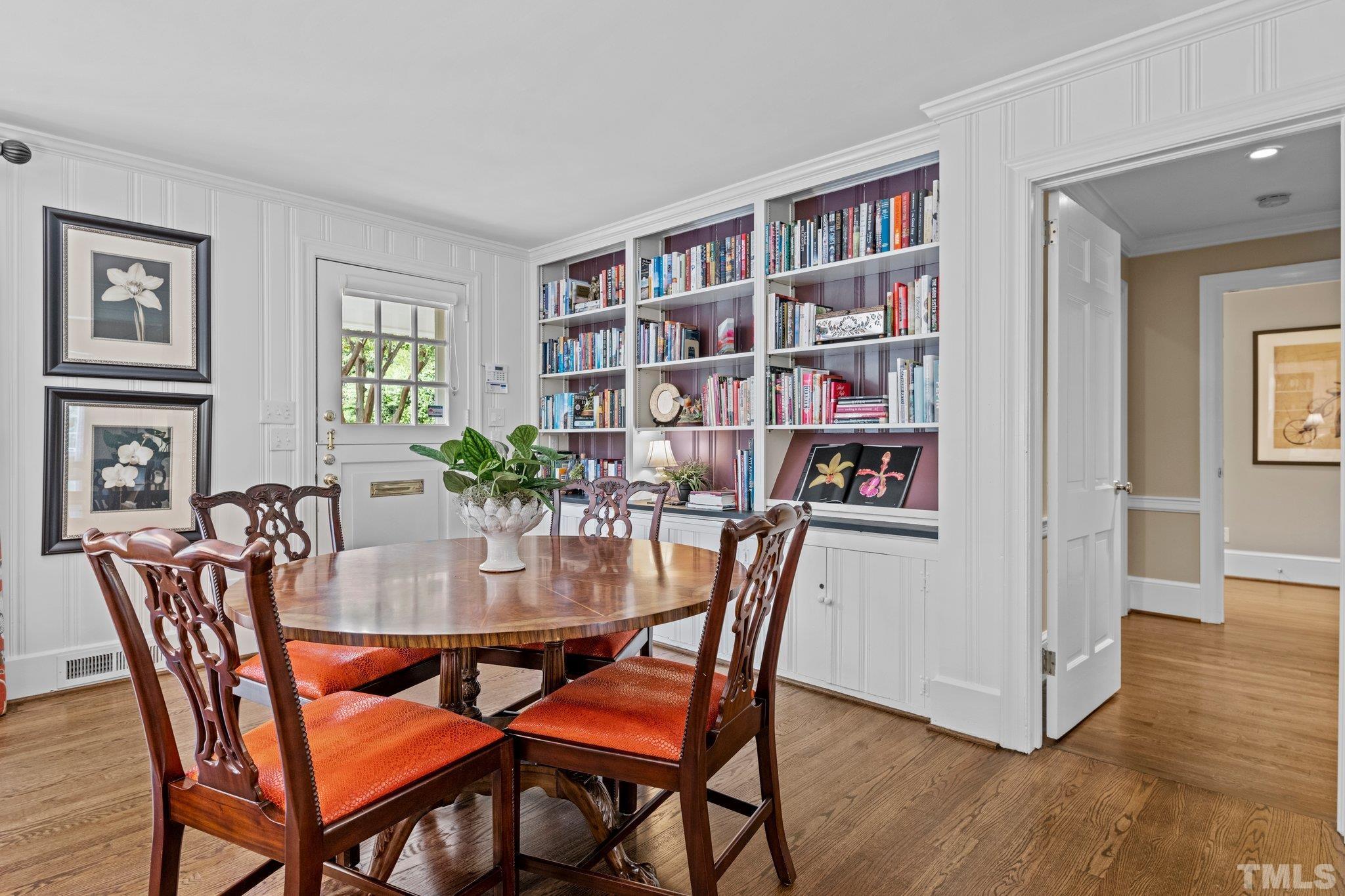 Breakfast Area in the Family Room with built-in bookshelves along the wall and Dutch Door to backyard.
