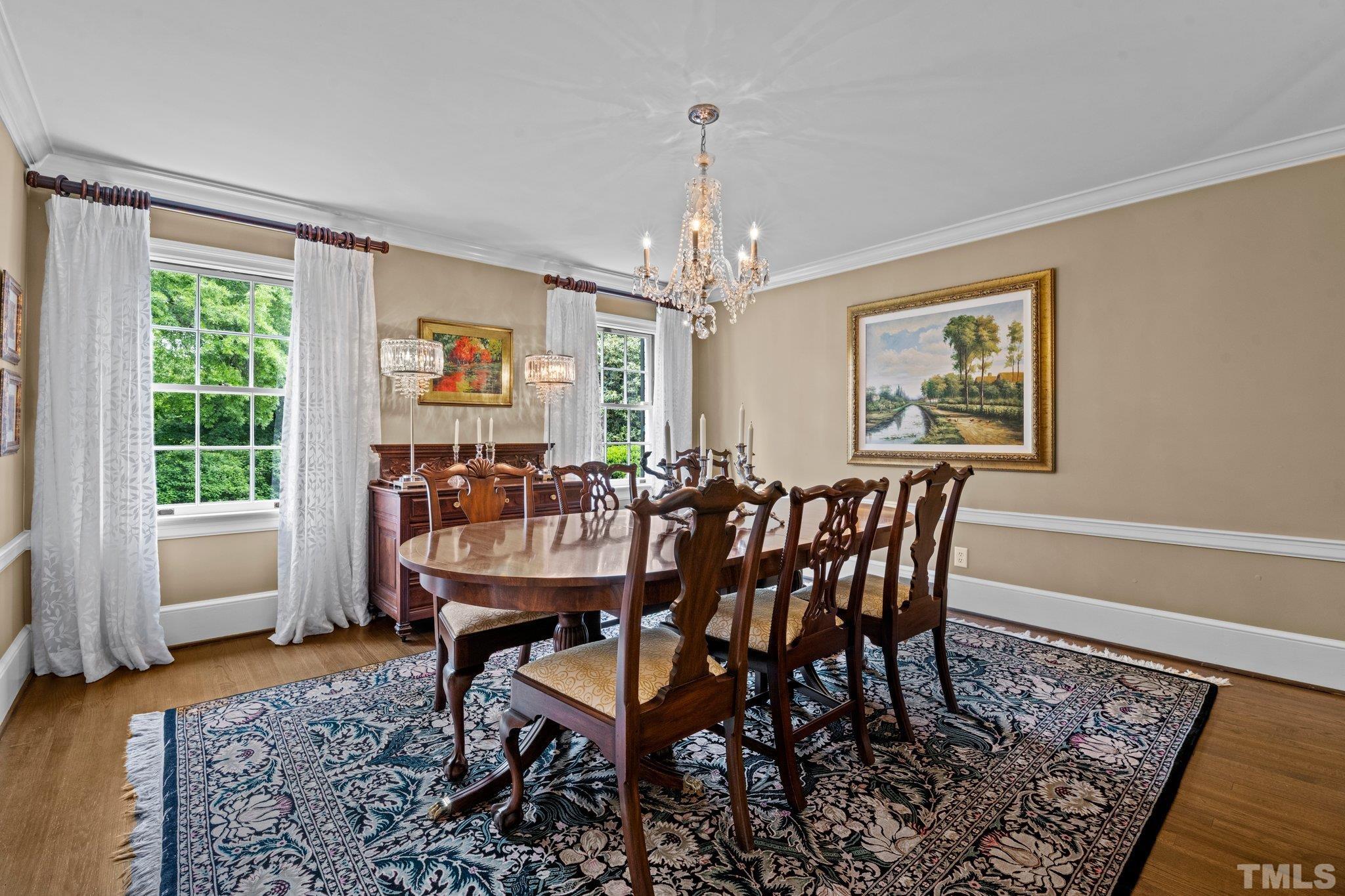 Separate formal Dining Room with smooth ceiling, crown molding, and two tall front windows.