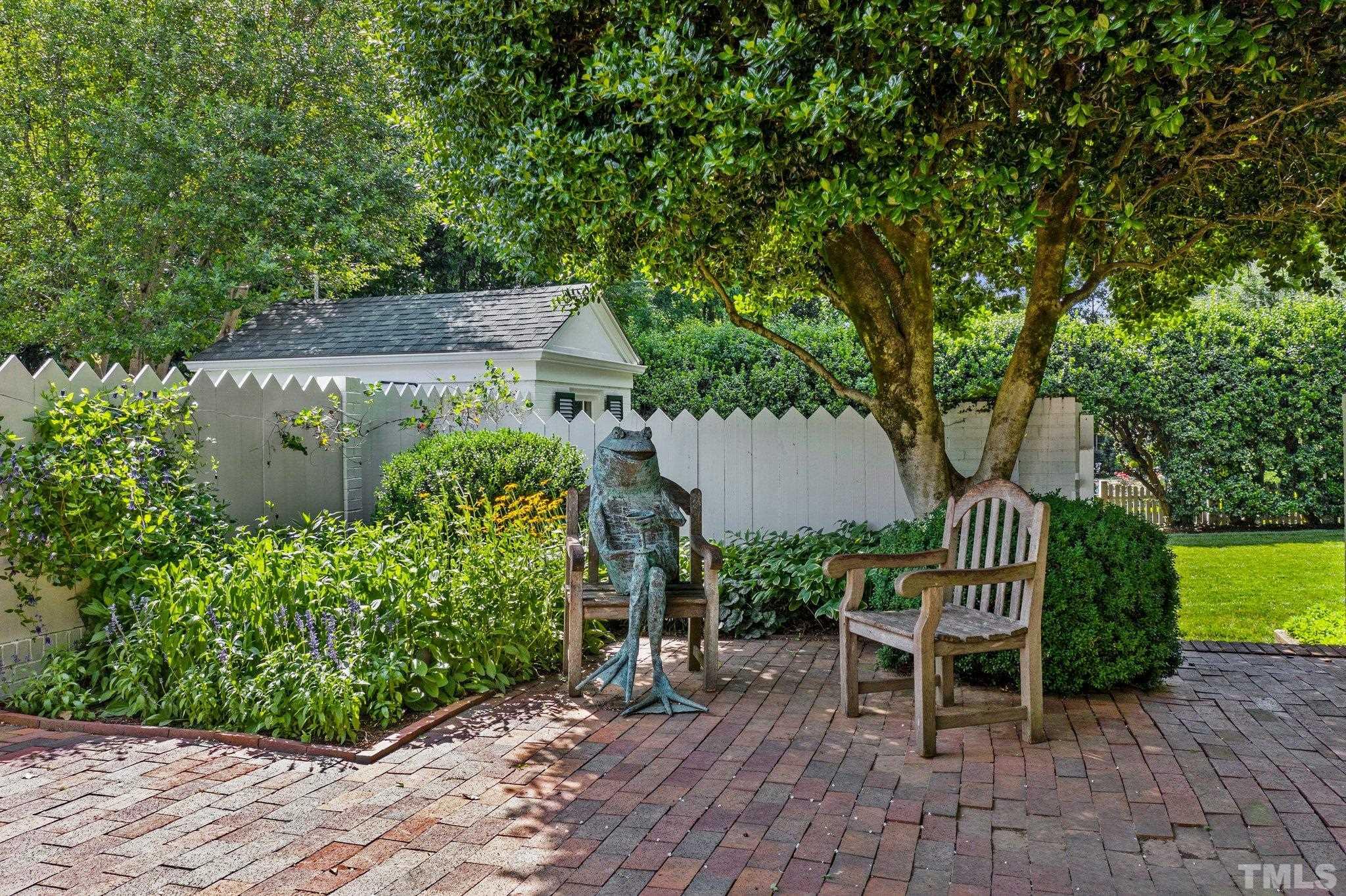 Unique patio with brick walls, multiple sitting areas and gardens-a peaceful oasis from the rest of Raleigh. The yard adds tranquility, reflection and ambiance to the landscape.