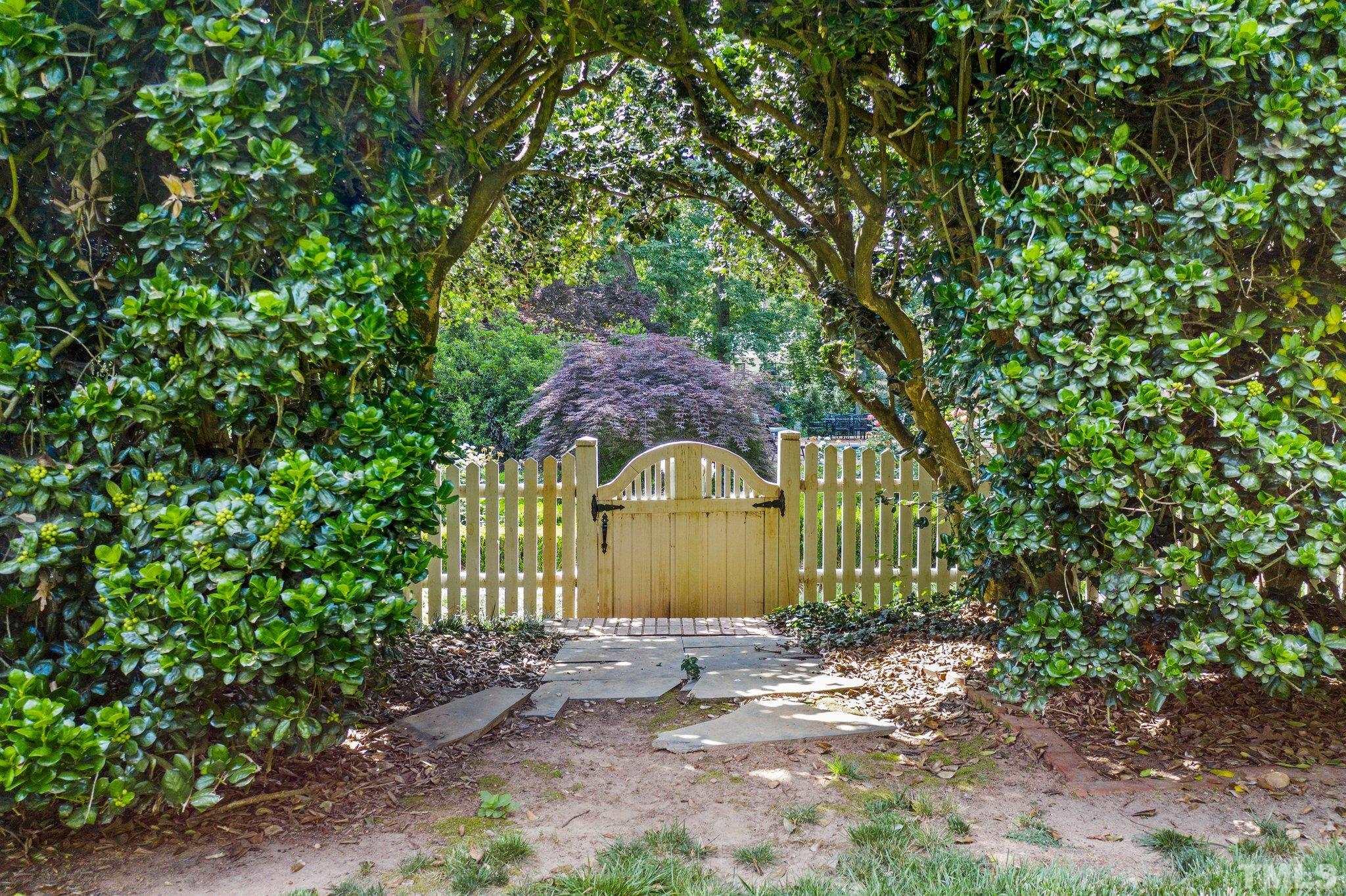 Beautiful archway and garden gate that leads from the back yard into a small section in the back. This yard has a lot of Secret Garden moments in it.