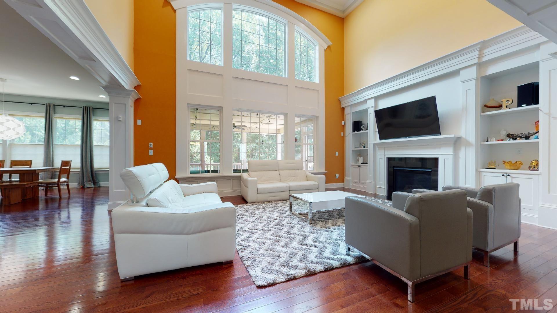 Two Story Great Room with large windows & coffered ceiling