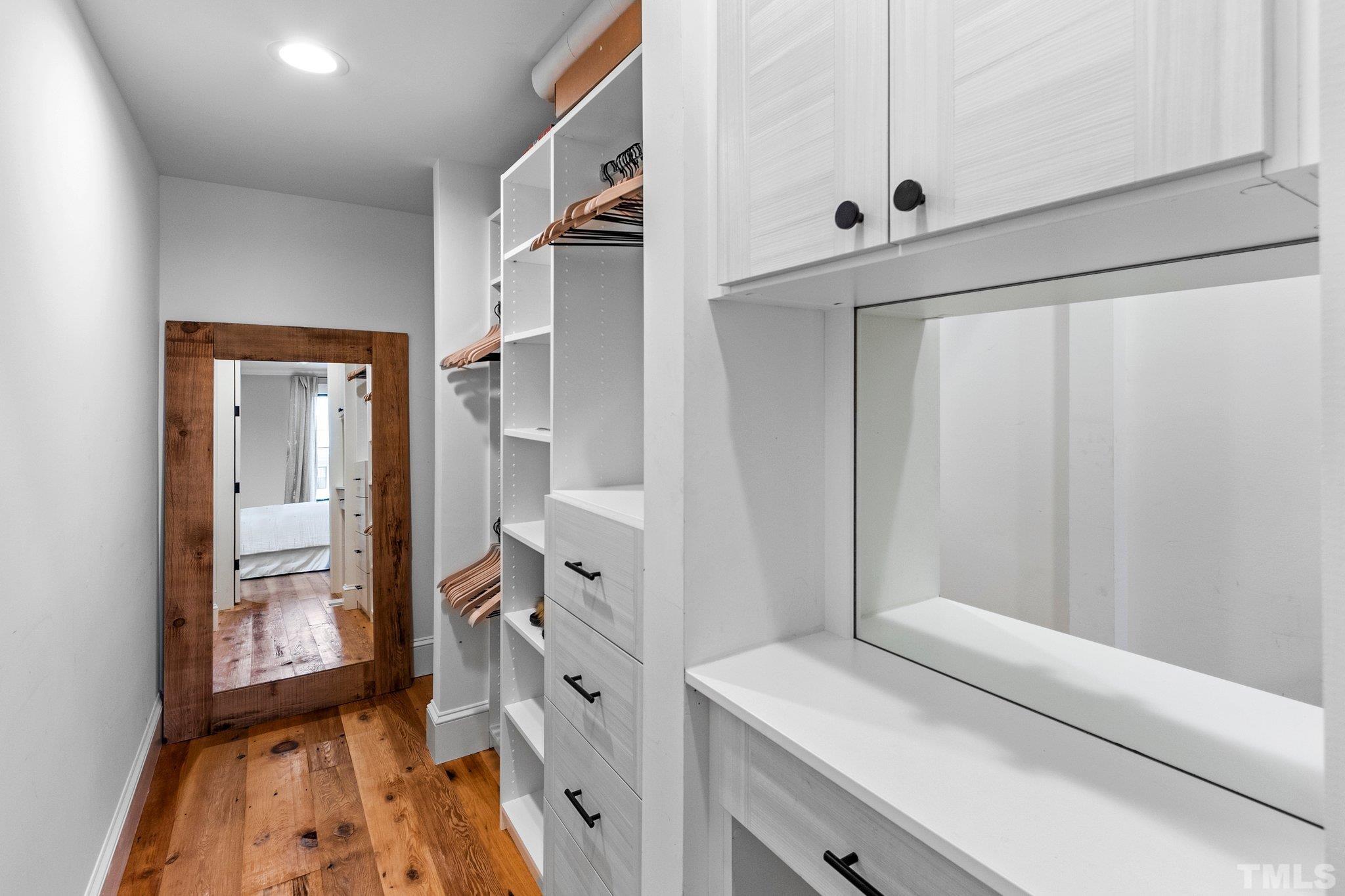 Walk-in Closet in first floor bedroom suite, complete with custom built-in shelving and cabinets.