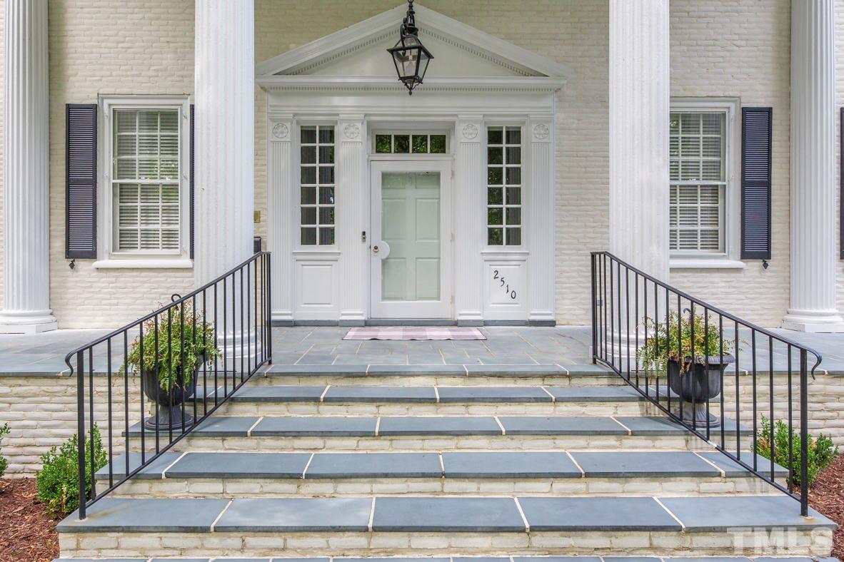 Entry with curved staircase and marble flooring