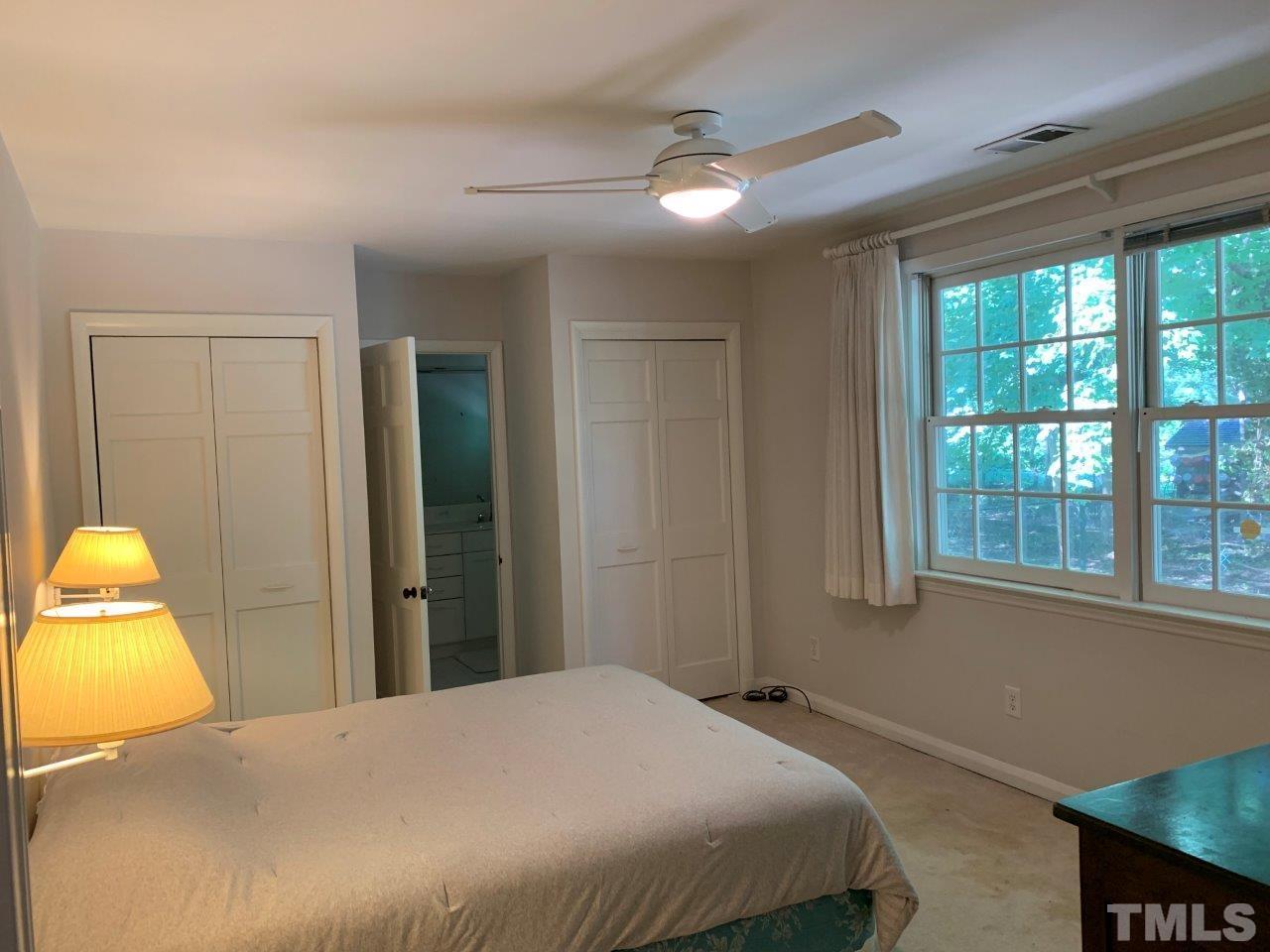 Master bedroom in 317 Patterson has a ceiling fan and en suite bath.