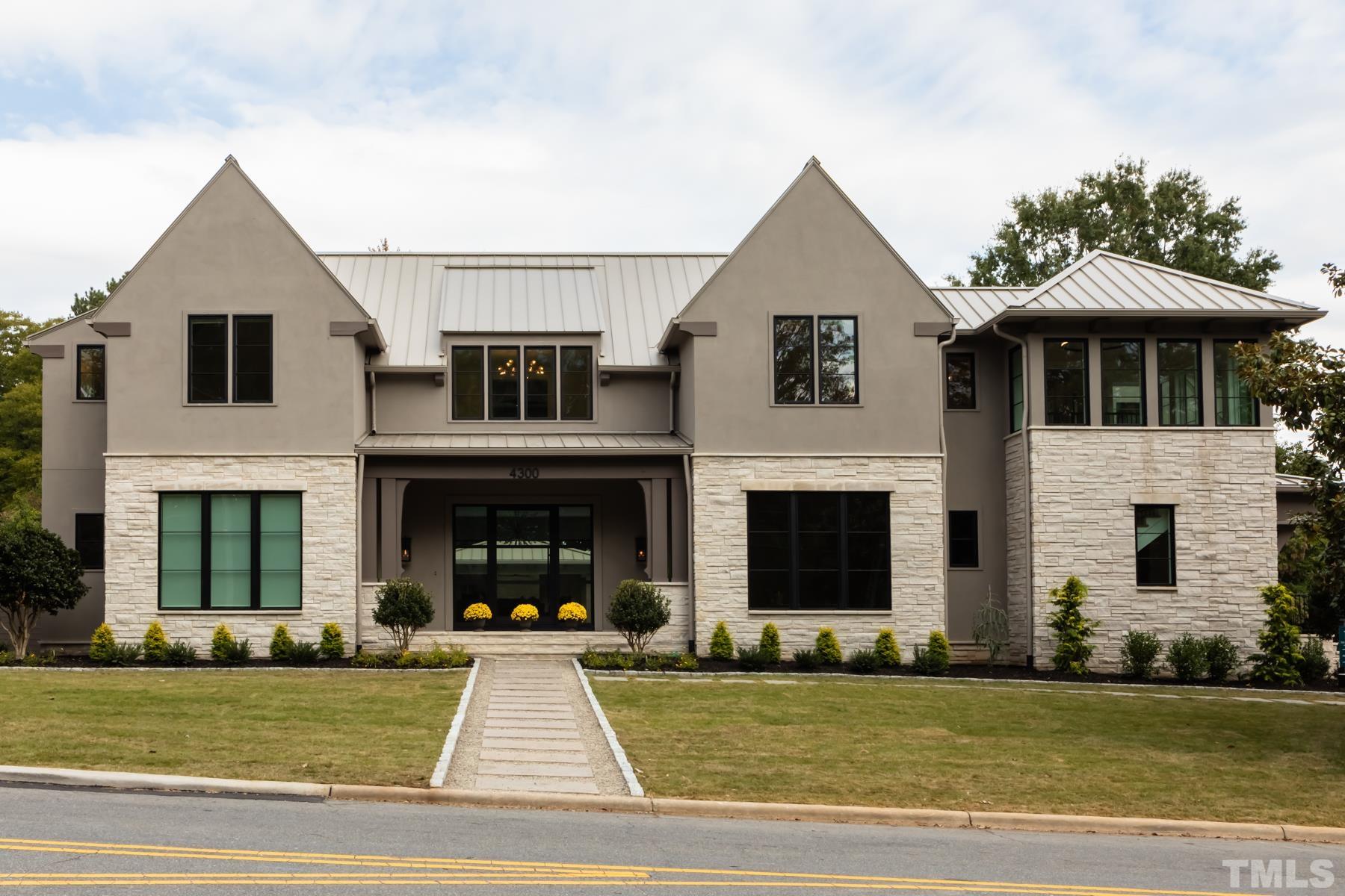 Gorgeous limestone, stucco and champagne standing-seam metal roof!